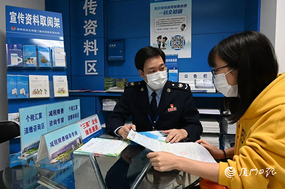 厦门象屿保税区税务局税务干部为纳税人就疫情期间的税收优惠政策进行解读。 厦门日报记者 黄晓珍 摄.jpg